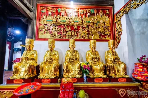 Chùa Long Tiên, nhiều tượng màu vàng, hoa văn màu đỏ, bức tường sơn màu trắng, lọ hoa