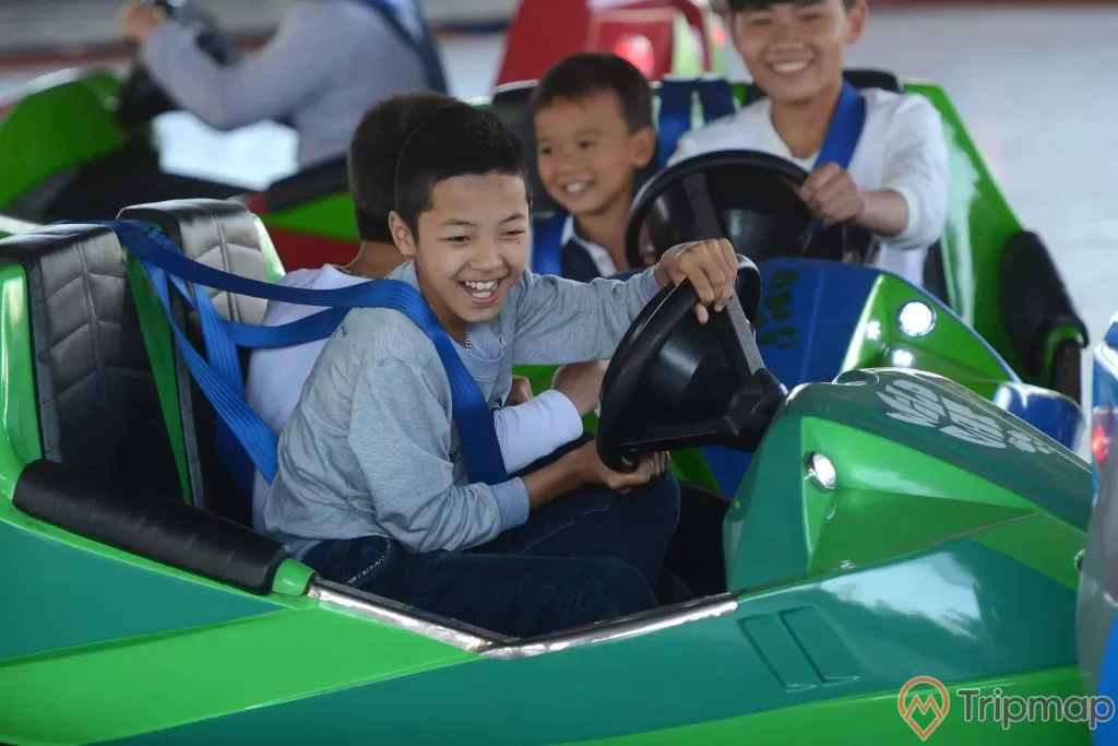 Bò sát đụng độ, các em bé đang lái chiếc xe màu xanh, các em bé đang cười
