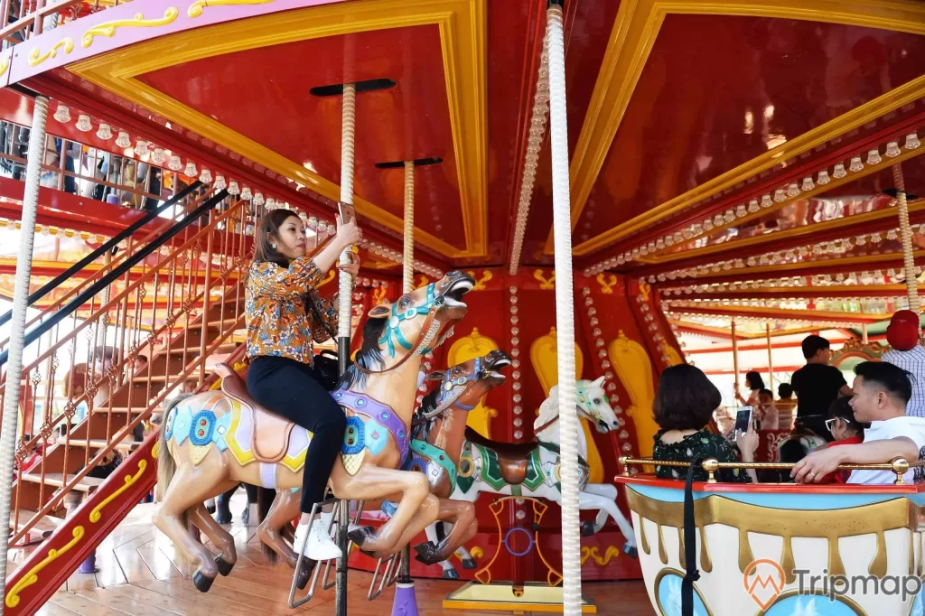 Royal Carousel, Đu Quay Kỳ Diệu, mô hình ngựa, người phụ nữ đang cưỡi ngựa, trụ quay màu nâu, ảnh chụp ban ngày