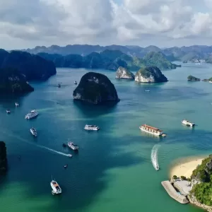 a body of water with islands and boats in it with Ha Long Bay in the background