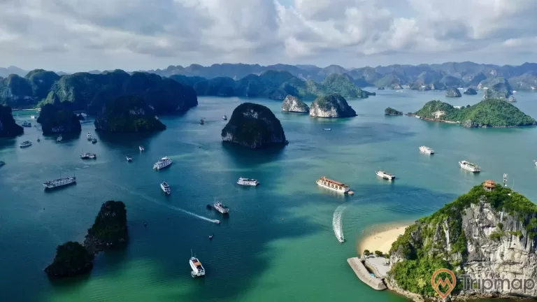 a body of water with islands and boats in it with Ha Long Bay in the background
