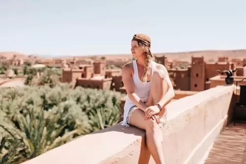 a person sitting on a ledge