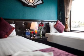 a bedroom with a bed and a lamp