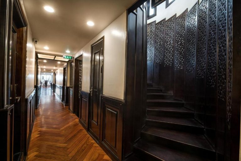 a long hallway with black railings
