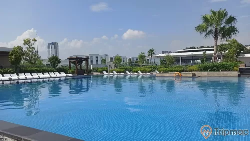 a pool with buildings in the background