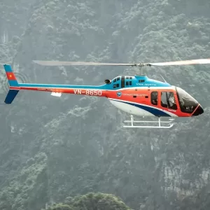 a helicopter flying over a forest